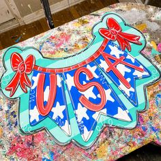 a close up of a piece of art with the word usa on it and bows