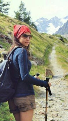 a woman with a backpack and hiking poles