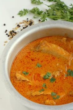 a white bowl filled with soup and garnished with cilantro