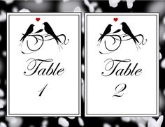 two birds are sitting on top of each other in the middle of a table number