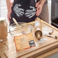 a woman standing in front of a wooden cutting board with ingredients on top of it