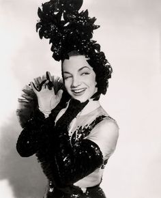 a black and white photo of a woman in costume