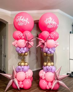 two pink and purple balloons with stars on them