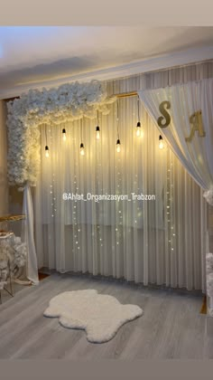 a room decorated with white flowers and lights