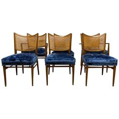 four chairs with blue velvet upholstered seats