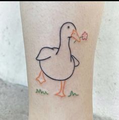 a duck with a flower in its beak is on the leg and it appears to be painted