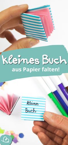 someone is holding some paper with the words keimes buch aus papier falten