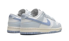 The Women’s Nike Dunk Low Next Nature "Blue Tint" is a women’s-exclusive version of the retro basketball sneaker made with environmentally-friendly materials.  The upper features a white leather base with University Blue leather overlay panels.  A Blue Tint leather Swoosh can be found on either side of the shoe and “Nike” branding is embroidered on the heel.  Classic “Nike” and Swoosh detailing is found on the tongue tag.  A white rubber midsole and royal outsole made with recycled Nike Grind ma Nike Dunk Low Next Nature, Nike Tenis, Nike X Travis Scott, Nike Branding, Low Air Jordan 1, Retro Basketball, Exclusive Sneakers, Dunks Nike, Adidas Spezial