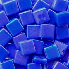 blue glass cubes are stacked on top of each other in this close up photo