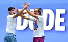 two tennis players are high fiving each other