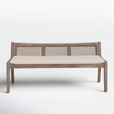 a wooden bench with a white cushion on the top and backrest, in front of a gray background