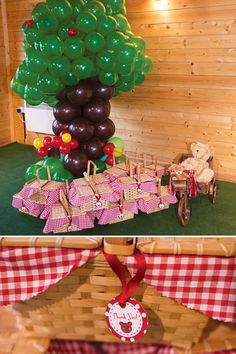 a table topped with lots of balloons next to a tree