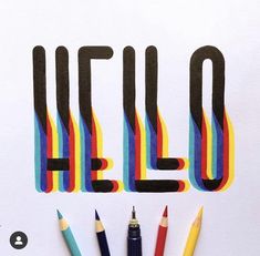 the word hello spelled out with crayons and pencils on a white surface