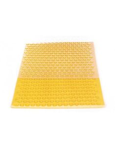 a yellow and white mat with circles on the bottom, in front of a white background