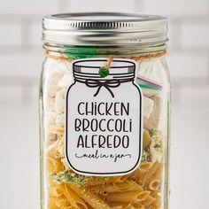 a jar filled with pasta and chicken broccoli alfredo