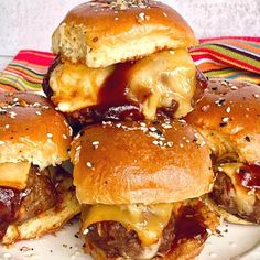 several hamburgers stacked on top of each other with cheese and meat in between them