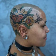 a woman with tattoos and piercings on her head