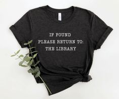 a t - shirt that says, if found please return to the library on it