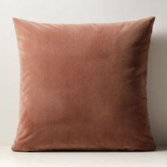 a brown pillow sitting on top of a white table