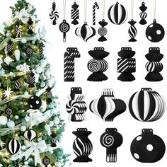 black and white ornaments are hanging on the christmas tree next to a decorated christmas tree