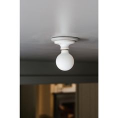 a white light fixture hanging from the ceiling