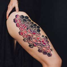 a woman with a tattoo on her leg that has hexagons and stars