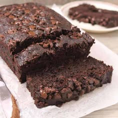 two slices of chocolate cake sitting on top of white napkins next to each other