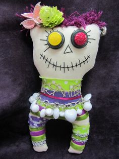 a stuffed doll with purple hair and green pants