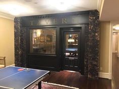 a ping pong table is in front of the entrance to tavern n, an upscale restaurant