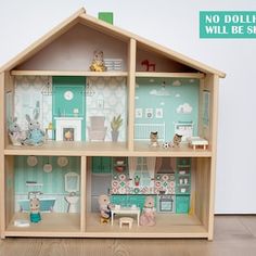 a doll house with all the furniture and accessories in it's display case on a hard wood floor