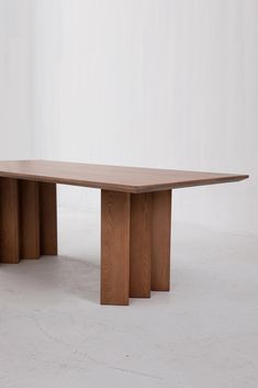 a wooden table sitting on top of a white floor