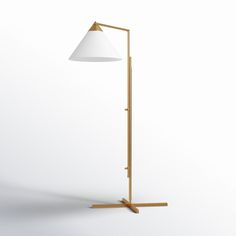 a floor lamp with a white shade on the top and a wooden pole underneath it