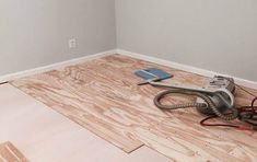 a room with hard wood flooring being installed