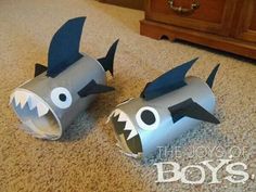 two paper mache sharks are on the floor