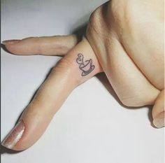 a person with a small tattoo on their finger