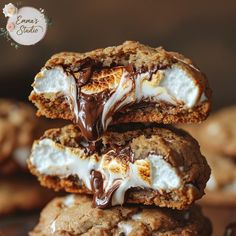 three cookies with marshmallows and chocolate drizzled on top