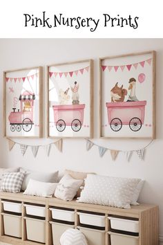 pink nursery prints are hung on the wall above a bench with storage bins underneath