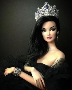 a barbie doll wearing a tiara and dress with jewels on it's head