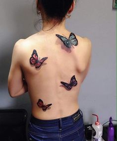 the back of a woman's body with butterflies on her upper and lower back