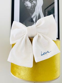 a yellow lamp with a white bow on it