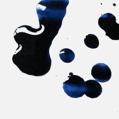 blue and black ink drops on white paper