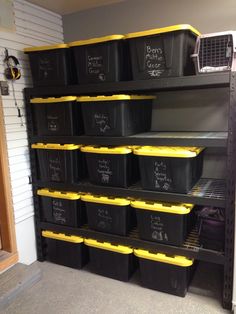 the shelves are filled with black and yellow bins