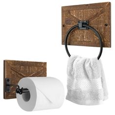 two toilet paper rolls are hanging on the wall next to a towel rack and wooden block