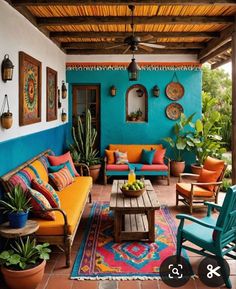 an outdoor living room with colorful furniture and potted plants on the side of the wall