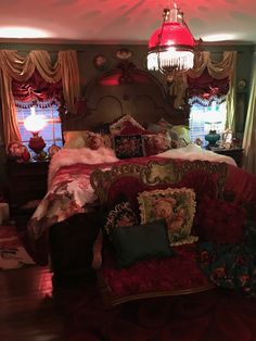 a bedroom with a bed, chair and chandelier