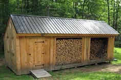 a small cabin with logs stacked in it