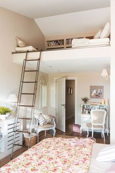 a bedroom with a loft bed, desk and ladder to the top level above it