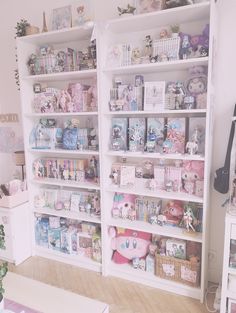 a room filled with lots of white shelves and stuffed animals on top of each shelf