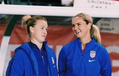 two women in blue jackets standing next to each other