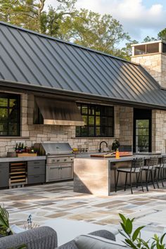 an outdoor kitchen and dining area is shown